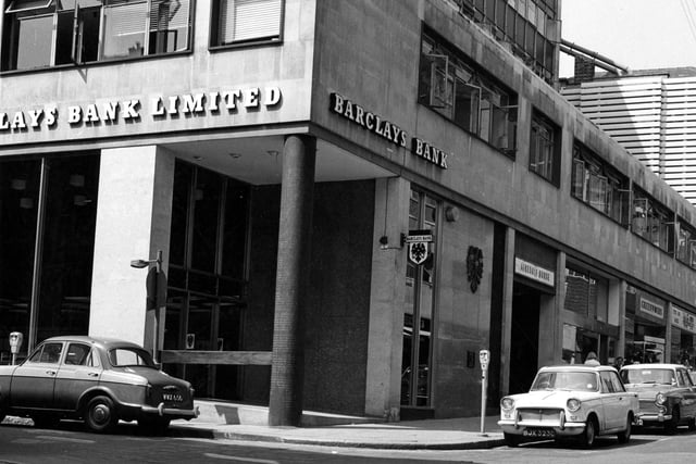 Barclays Bank on the corner of Albion Street in June 1967 with Airedale House next door to it. Cars are parked on the street by parking meters. These include a Triumph Herald, Rover, Humber, Wolseley and Cortina.