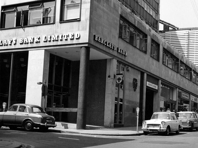 Barclays Bank on the corner of Albion Street in June 1967 with Airedale House next door to it. Cars are parked on the street by parking meters. These include a Triumph Herald, Rover, Humber, Wolseley and Cortina.