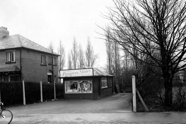 Progress Stores, a small grocery shop on the east side of King Lane pictured in January 1955. It is a single storey wooden structure selling butter, eggs and bacon, also tinned and packet goods.