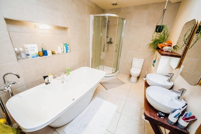 The main house bathroom with free standing bath, shower cubicle and twin wash hand basins.