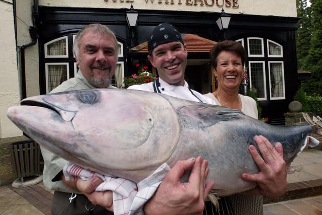 The newly-refurbished White House pub near Roundhay, celebrating its reopening by launching its ‘Catch of the Day’ menu. Pictured is head chef at Mark Bennett, holding a 35 kilo tuna fish, along with landlord and lady John and Kath Hanley on September 24, 2002. Picture: Charles Knight.