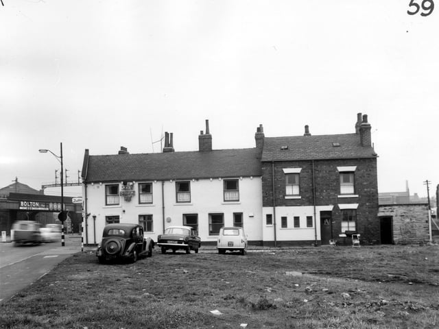 A view looking from waste ground onto Broadbent Court in March 1965. On the left edge, Gelderd Road is visible with the railway bridge above. In the centre is the Skew Bridge Inn which was number 19 Gelderd Road.