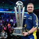 Darts world champion Luke Littler with the Sid Waddell Trophy. Picture by Taylor Lanning/PDC