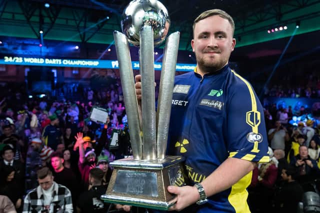 Darts world champion Luke Littler with the Sid Waddell Trophy. Picture by Taylor Lanning/PDC
