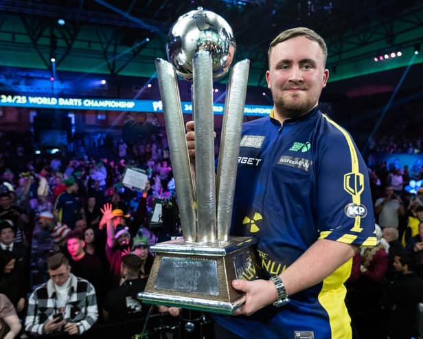 Darts world champion Luke Littler with the Sid Waddell Trophy. Picture by Taylor Lanning/PDC