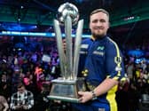 Darts world champion Luke Littler with the Sid Waddell Trophy. Picture by Taylor Lanning/PDC