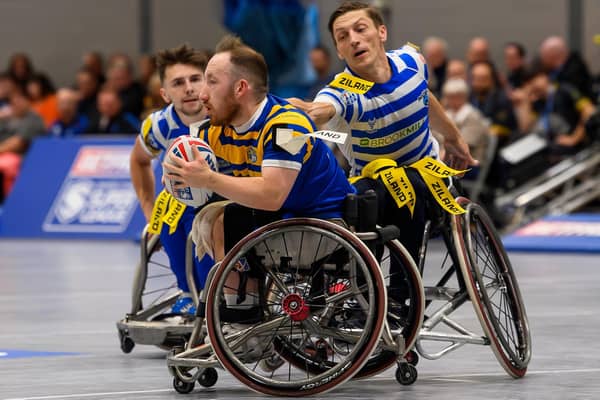 Leeds Rhinos' Nathan Collins evades a tackle by fellow England star Jack Brown, of Halifax Panthers, in the Betfred Wheelchair Super League Grand Final. Picture by Allan McKenzie/SWpix.com.
