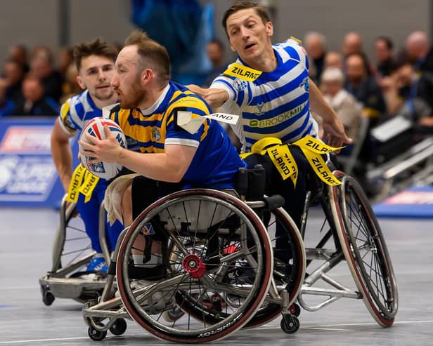 Leeds Rhinos' Nathan Collins evades a tackle by fellow England star Jack Brown, of Halifax Panthers, in the Betfred Wheelchair Super League Grand Final. Picture by Allan McKenzie/SWpix.com.