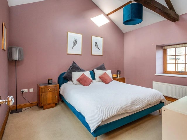 The master and bedroom three have high ceilings with original beams.
