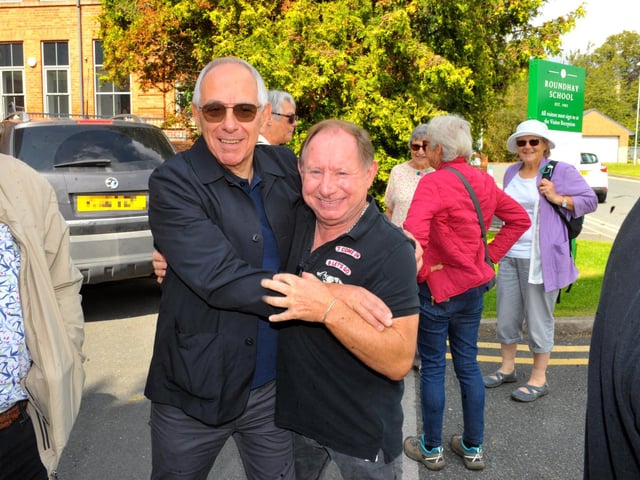 Neil Brosgill gives Harvey Harris a hug