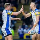 Ash Handley, right, is congratulated by Lachie Miller after scoring for Leeds Rhinos against London Broncos. Picture by Allan McKenzie/SWpix.com.