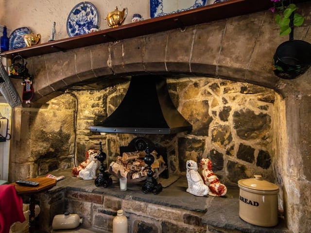 A close look at the stunning stone fireplace that is an original feature within the Hall.