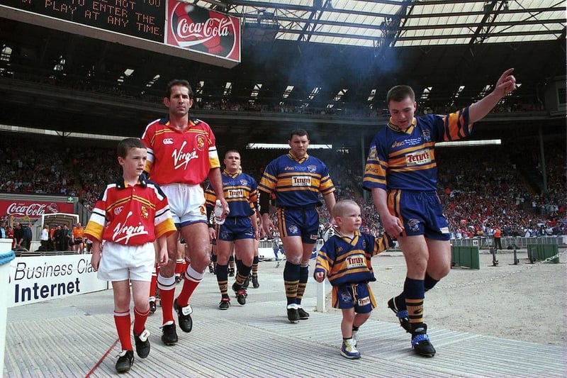 The teams enter the stadium bowl. Rhinos were led out by captain Iestyn Harris and matchday mascot Billy McDermott, the young son of prop Barrie McDermott who was second in line.