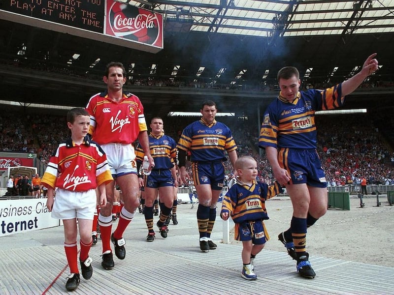 The teams enter the stadium bowl. Rhinos were led out by captain Iestyn Harris and matchday mascot Billy McDermott, the young son of prop Barrie McDermott who was second in line.