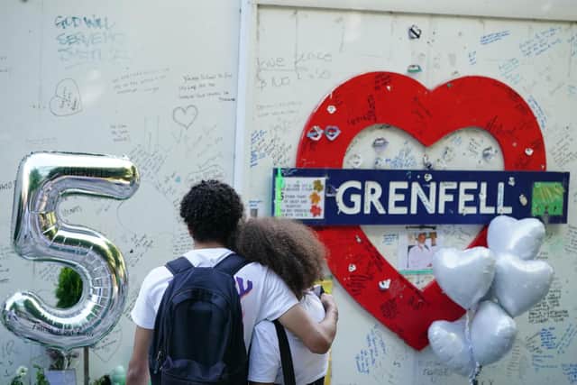 Members of the public at the memorial at the base of Grenfell Tower in London (Photo: Dominic Lipinski/PA Wire)