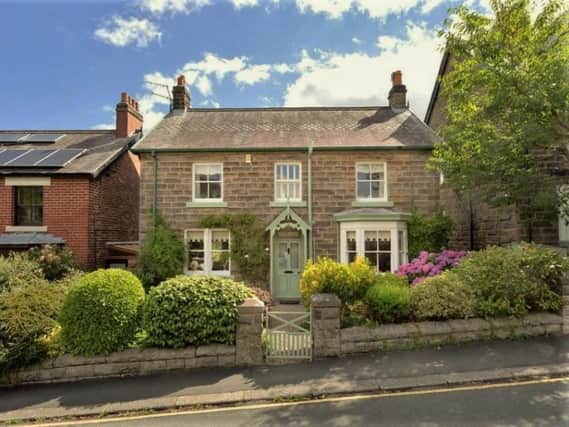 This stone cottage with far-reaching views to front and rear is for sale priced at £560,000.