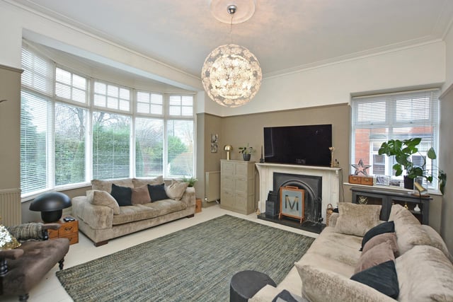 There is a light and elegant living room to the front enjoying a double aspect afforded by a circular bay window to the front elevation and additional window to the side, and a focal fireplace in cast iron grate with decorative surround.