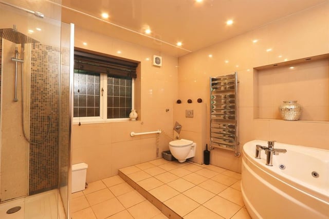 The family bathroom has a four piece suite including a corner bath, spa shower, wash hand basin set in a vanity unit and low level wc, tiled walls and floor, window to the side and heated towel rail.
