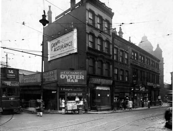 Call Lane in September 1943. The junction with Kirkgate is on the far right, with The Mason's Arms (Tetley's Ales), at the end. Then come numbers 4 to 8, King's (Leeds) Ltd, boots and shoes, (with A. Moss, hairdresser, above); numbers 10 and 12, Grant's Confectioners; number 14 is the empty Mellophone Co, (wireless dealers), shop, which is now to let. Number 16 is Thomas Haye's Oyster bar, which has a handcart outside. On the left a number 14 tram (to Half Mile Lane, via Bramley) is pulling out of New Market Street.