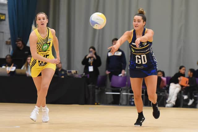 Michelle Magee plays a pass while watched by England Roses international Natalie Metcalfe (Picture: MATTHEW MERRICK PHOTOGRAPHY)
