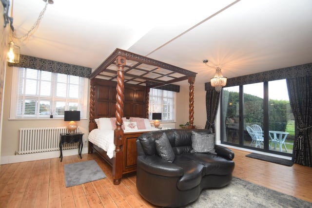 One of the double bedrooms, with access to a patio and the gardens.