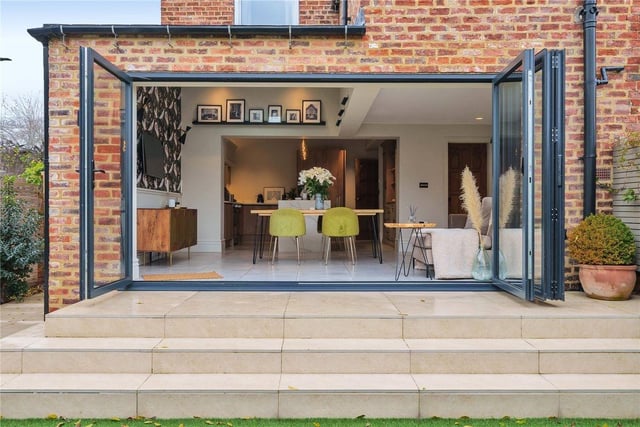 The downstairs kitchen gracefully opens onto the landscaped rear garden with bi-folding doors.