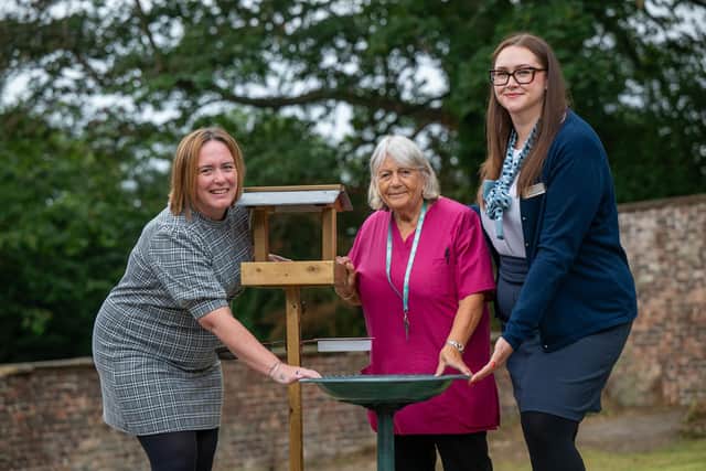 B&DWYW - SGB-45016 - Sales Adviser Rachel presenting the bird bath and table to Burley Hall Care Home