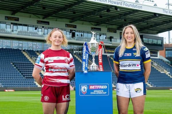 Rhinos' Caitlin Beevers, right and Mary Coleman, of Wigan, with the Women's Challenge Cup at Headingley, where Sunday's semi-final will be played. Picture by Allan McKenzie/SWpix.com.