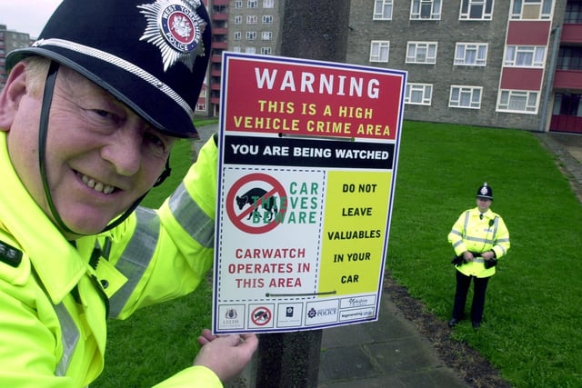 Community bobby PC Tony Sweeney, left, helps  too put up West Yorkshire Police warning signs about vehicle crime around the Lincoln Green area in October 2001. He is watched by PC Tony Walker, a section officer at Chapletown.