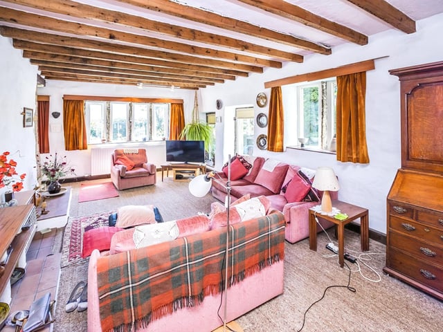 Original ceiling beams and stone mullions to the windows add to the charm of this spacious lounge.