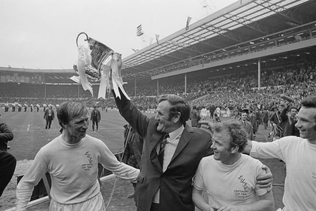 Leeds United F.C. manager Don Revie lifts the 'FA Cup' trophy after his players beat Arsenal F.C. to win the FA Cup Final, Wembley Stadium, London, 6th May 1972. Also shown are Jack Charlton (left), Billy Bremner, and Paul Reaney (far right). (Photo by Express/Hulton Archive/Getty Images)