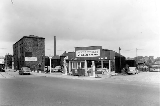 Whingate Garage on Tong Road pictured in August 1961.  To the left is a clothing factory, business of T. Conaty. Whingate Garage is in the centre, owned by Arnold Stainsby, the premises include a car showroom.
