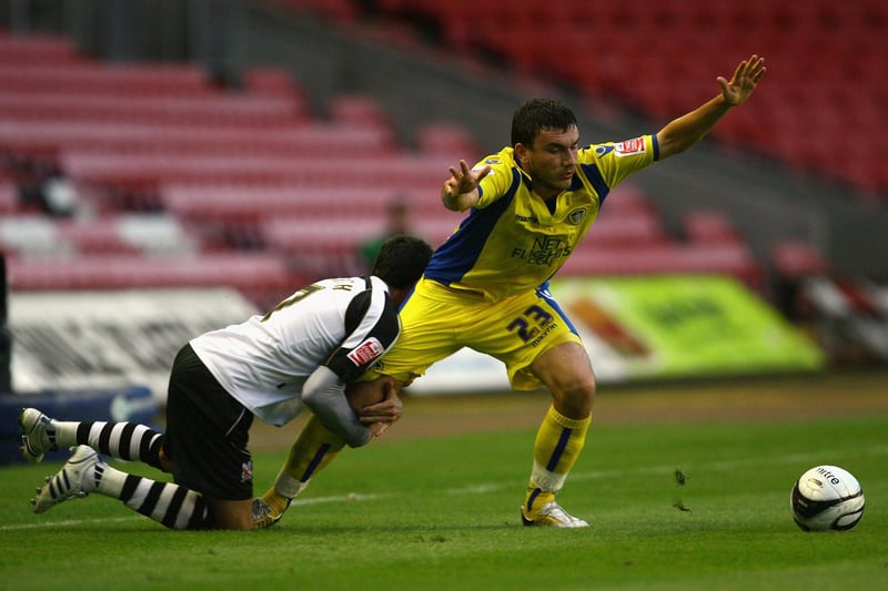 Robert Snodgrass of Leeds United is held back by Jeff Smith of Darlington during the Carling Cup First Round match between Darlington and Leeds United at the Northern Echo Darlington Arena. (Photo by Alex Livesey/Getty Images)