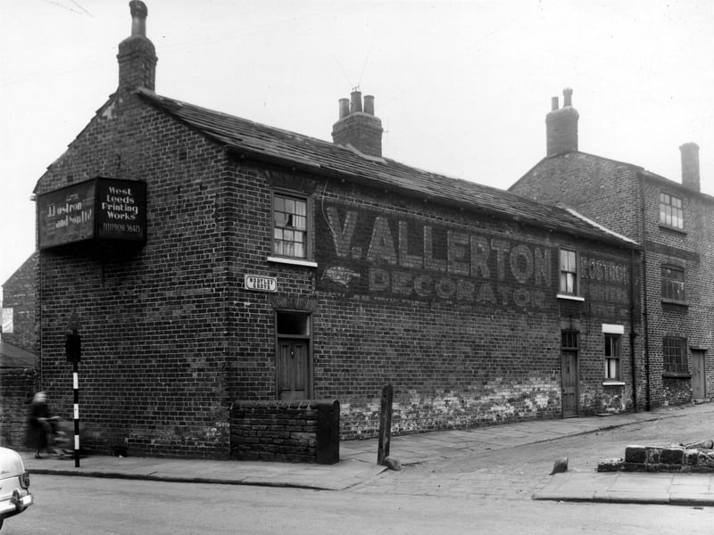 This view looks from Green Lane onto Wortley Grove, the former location of two businesses. V. Allerton, decorator had occupied number 3, with number 5 on the right edge being the West Leeds Printing Works, business of J. Rostron and Son Ltd. Number 1 is a private residence. Pictured in May 1959.