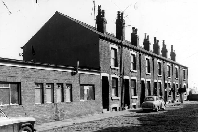To the left is the back of Hunslet Motor Co Ltd premises which fronted onto Low Road. The houses number from 11 next to the garage to 23 on the right. These were through houses with entrances on Low Road where they numbered 128 - 140. They were also called Spring Grove Terrace. Pictured in April 1968.