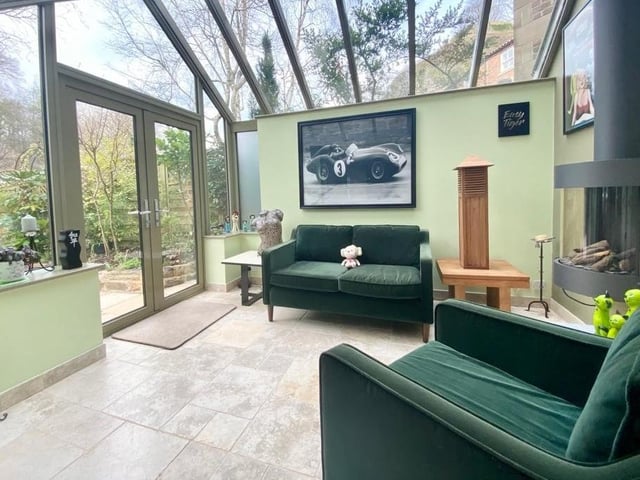 The orangery has a feature living flame gas fire, and doors out to the riverside patio.