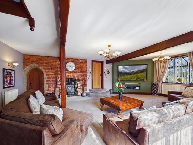 The heart of the home is the lounge area, which is centred around an original brick-built fireplace and has a media wall and character beams.