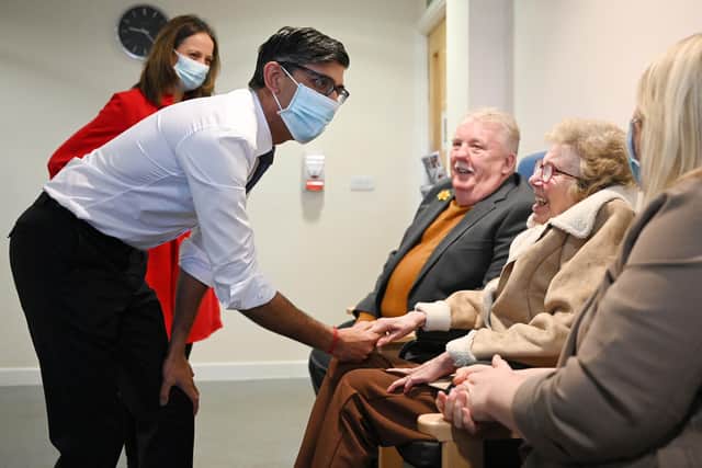 Prime Minister Rishi Sunak wearing a face mask meets with patient Pauline Burke (sitting centre) with her daughter Emma (right) and husband Patrick with Minister of State for Social Care Helen Whately (back left) during a visit to the Rutland Lodge Healthcare Centre in Leeds (Photo: Oli Scarff/PA Wire)