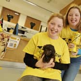 Tilly (front) and twin sister Hattie met puppy Olive when they went to Dogs Trust Leeds to hand over the money they raised
