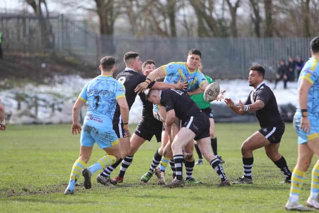 Third round Challenge Cup action as Stanningley's defence wraps up Mitch Clark, of Newcastle Thunder. Picture by Alex Shenton.
