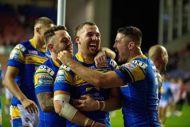 Richie Myler, Cameron Smith and James Bentley celebrate at full-time in Rhinos' semi-final win over Wigan. Picture by Bruce Rollinson.