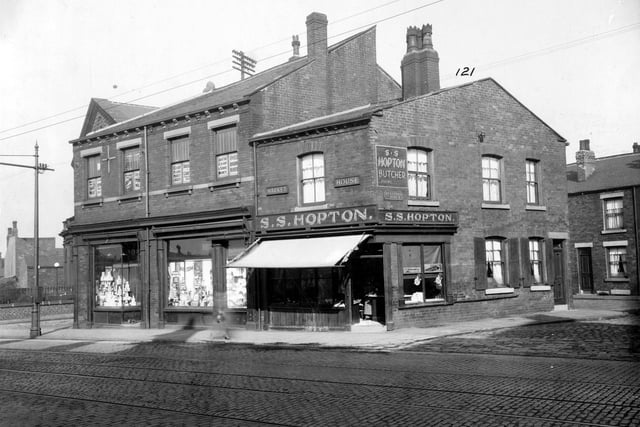 York Road in September 1935. On the left is Bickerdike Road Corner and centre shop, at nos. 97 and 99, Leeds Industrial Society. Painted windows on second floor advertise own-brand products including bread, cheese, milk and flour. To the right, no.101 has name 'Market House' on the wall, premises of Samuel S.Hopton, butcher. The shop also has a window on Bickerdike Street, to the right.