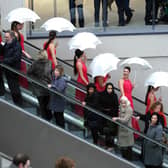 Models from Coast agency on the escalators for the opening of Trinity Leeds.
