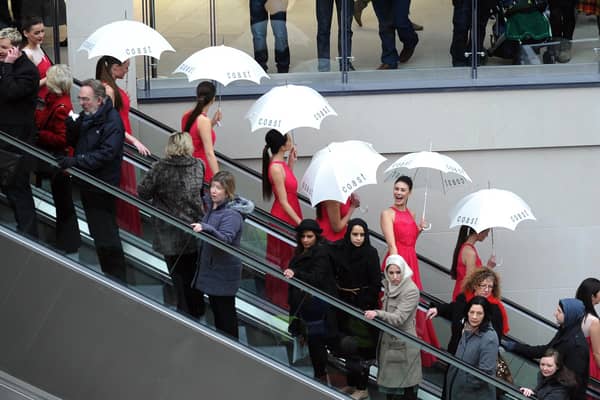 Models from Coast agency on the escalators for the opening of Trinity Leeds.
