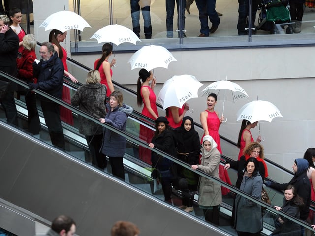 Models from Coast agency on the escalators for the opening of Trinity Leeds.