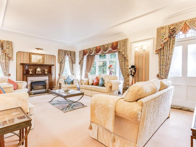 A carpeted reception lounge with feature fireplace.