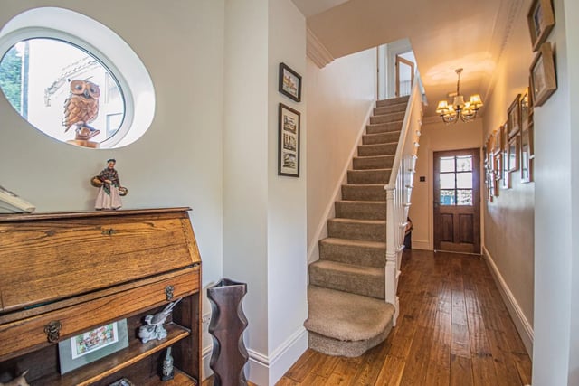 A spindle staircase leads up to the first floor landing and bedrooms from the hallway.