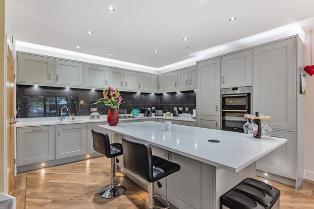 Downstairs, an airy entrance hallway leads into a modern style fitted kitchen and diner, with integral appliances including a dishwasher, gas hob, extractor fan, double oven and a utility room.