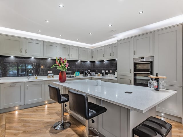 Downstairs, an airy entrance hallway leads into a modern style fitted kitchen and diner, with integral appliances including a dishwasher, gas hob, extractor fan, double oven and a utility room.