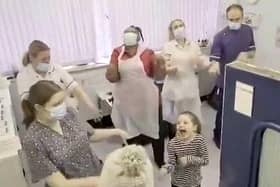 A heartwarming video shows the moment nurses learnt a viral TikTok dance inspired by a Netflix series to help calm down a young girl who was having a blood test (Photo: SWNS)